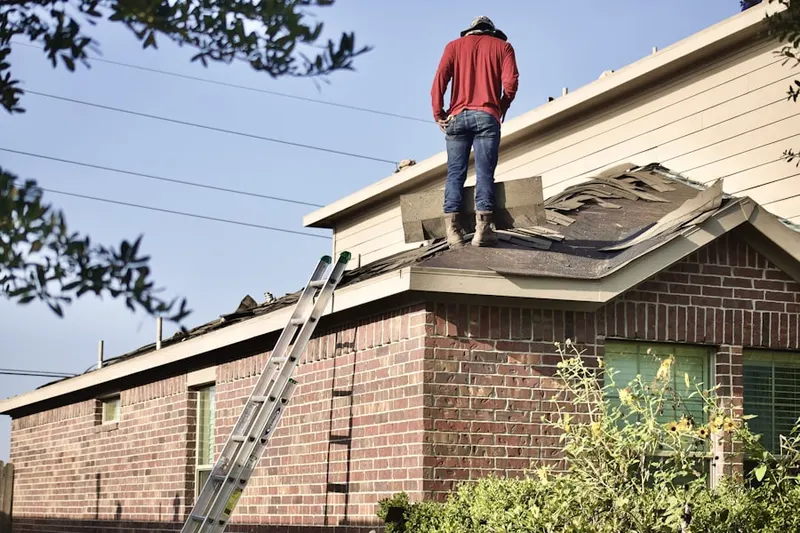 Professional roofer working on a residential roof in Gypsum